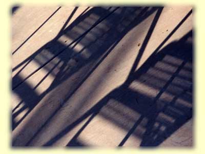 photo of the shadow of two chairs